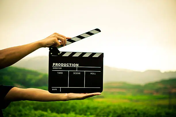 Photo of clapper board with hand