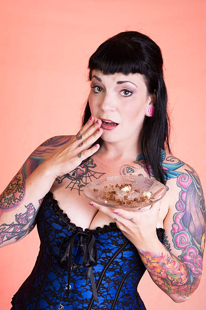 istock Embarrassed pinup model with plate of crumbs 186581550