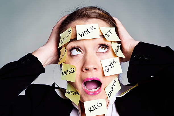 istock panic as businesswoman is overwhelmed by task reminder labels 186581571