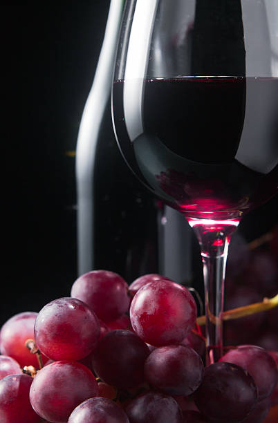 istock grape and glass with red wine 186581645