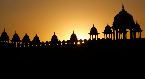 The sun sets behind a palace in Jaipur India.