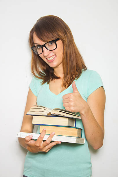 istock Young female student with books on white. 186583433