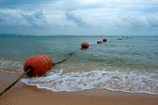 Scenic view of the sea with a single yellow plastic foam floating on a sea surface contaminated the sea and ecosystem of sea life. Environmental contamination caused by human activity requiring the environmental cleanup.