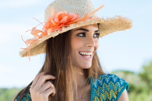 Portrait Of Cheerful Young Woman With Floral Sunhat