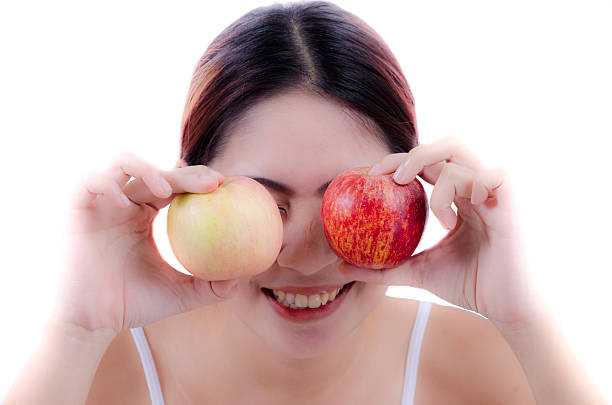 istock beautiful woman smile and an apple 186585512
