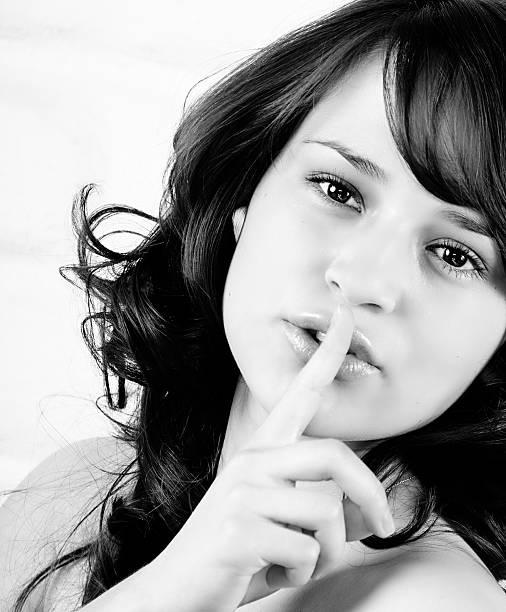 istock Beautiful Brunette Shushing, Holding finger on Lips 186586469