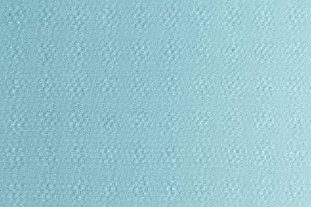istock Authentic fine Thai silk fabric textile detailed background in light pale blue green teal color tone 1865899184