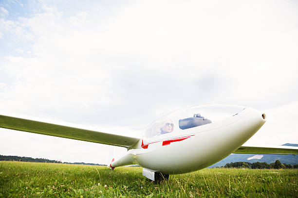 istock young woman sitting in glider plane 186590033