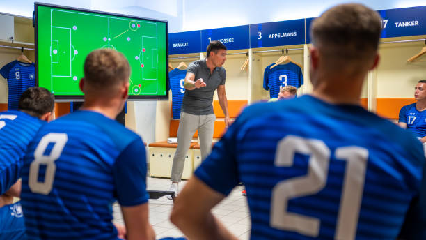 istock Soccer coach showing players positioning on screen 1865901344