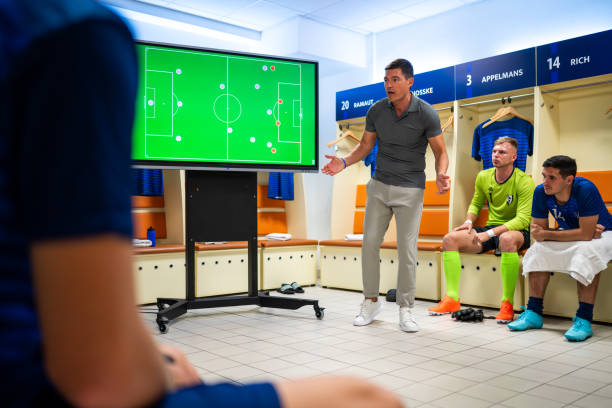 istock Soccer coach showing players positioning on screen 1865901347