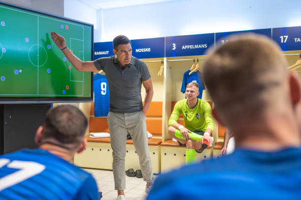 istock Soccer coach showing players positioning on screen 1865901349