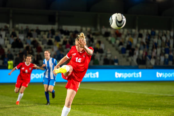 istock Female soccer player  kicking ball 1865901351