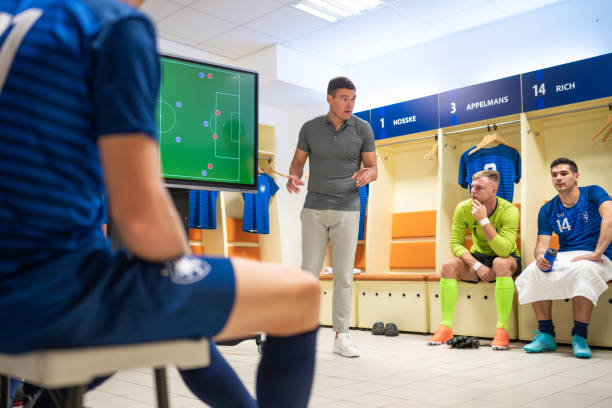 istock Soccer coach showing players positioning on screen 1865901352