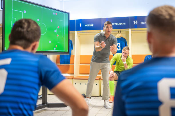 istock Soccer coach showing players positioning on screen 1865901354