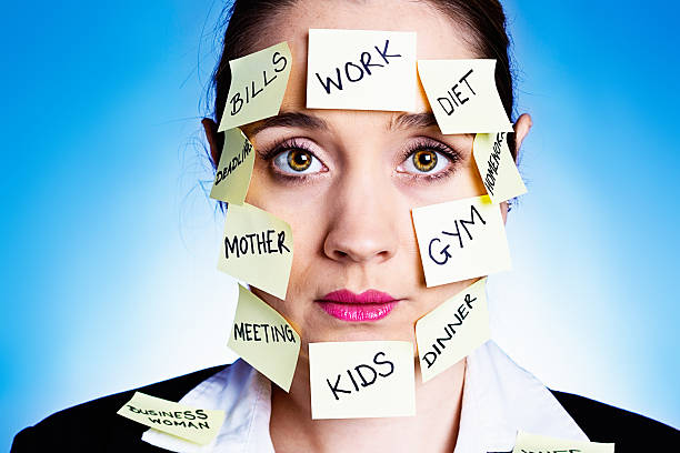 istock Overtired, overwhelmed woman covered in task and role reminders 186590974