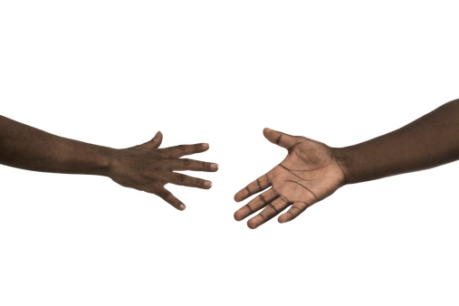 A woman and man hands reaching for each other