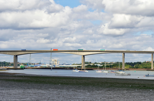 A procession of lorries on the Orwell Bridge, which crosses the River Orwell at Wherstead, near Ipswich in Suffolk, England. The bridge carries the A14 road and was opened for traffic in late 1982.