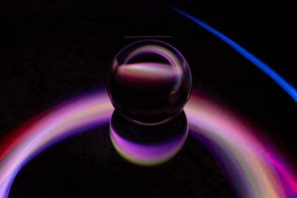 istock Dancing rays of colored light magically surround this sphere 1865946982