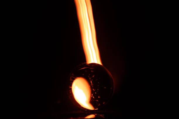 Glass bends light in fascinating ways, and this sphere demonstrates that beautifully with various colors on a dark background.