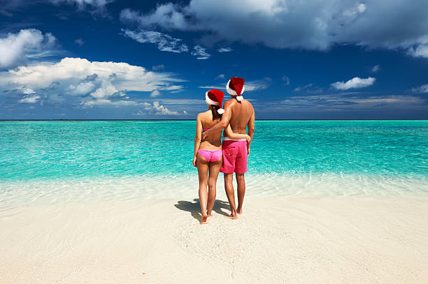 istock Couple in santa's hat on a beach at Maldives 186594946