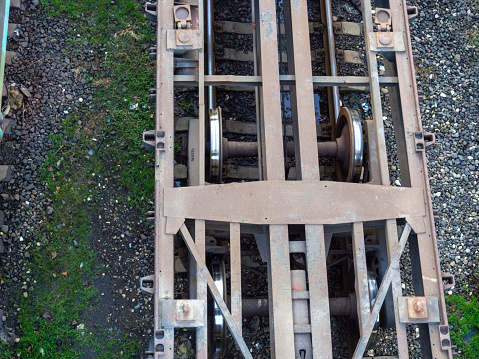 Empty freight train cars. Cars without a roof. Freight transportation. Freight train cars in the parking lot. Platforms