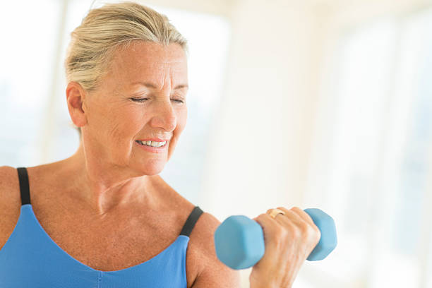 istock Woman Exercising With Dumbbell At Home 186595761