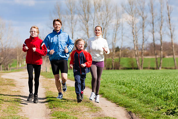 istock Family running together on a dirt road 186596018