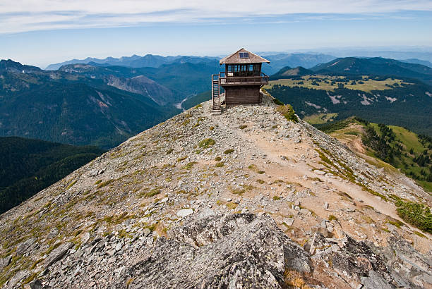Historic Mount Fremont Fire Lookout The Mount Fremont Fire Lookout is a rustic style building in the northern part of Mount Rainier National Park. It sits on top of a rocky outcrop at an elevation of 7317 feet above sea level. The building is maintained as a historic structure and is no longer used as a fire lookout. The lookout was placed on the National Register of Historic Places on March 13, 1991. Mount Fremont Lookout is located near Sunrise in Mount Rainier National Park, Washington State, USA. jeff goulden fire lookout stock pictures, royalty-free photos & images