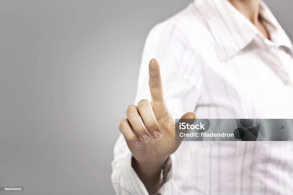 Businesswoman pressing button on touch screen Adult Stock Photo