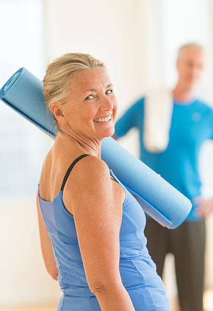 istock Senior Woman With Exercise Mat At Home 186598412