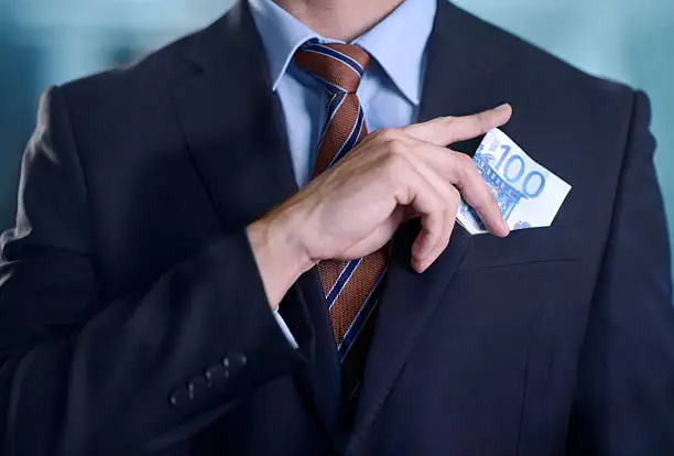 Cropped image of a businessman with a lot of cash