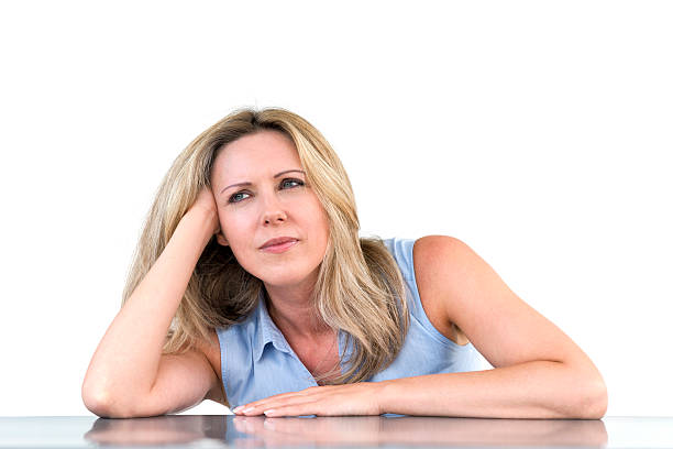 istock pensive woman sitting at desk 186600210