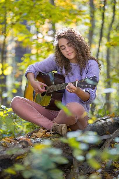 istock Pretty Young Musician Playing Guitar 186600477