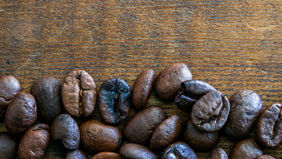 Coffee beans on browm wooden background