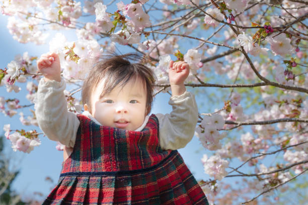 istock pretty girl play with flower in spring 1866029082