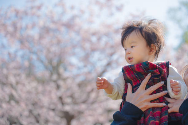 istock pretty girl play with flower in spring 1866029111
