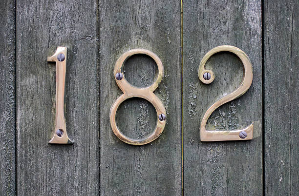 istock Metal number 182 on wooden gate 186604606