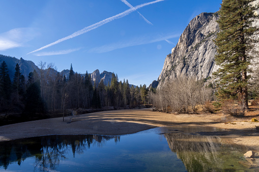 A lovely spot along the Merced River offering beautiful scenery of Yosemite valley, known for its peaceful ambiance and stunning views of the surrounding granite cliffs and forested landscape.