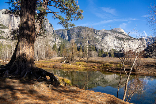 A lovely spot along the Merced River offering beautiful scenery of Yosemite valley, known for its peaceful ambiance and stunning views of the surrounding granite cliffs and forested landscape.