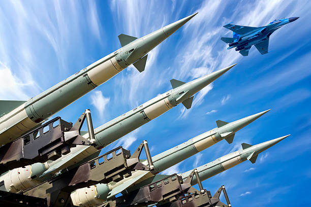 Ready for war Medium range self-propelled anti-aircraft missiles S-125 Neva ready to launch and fighter aircraft SU-27 in background anti aircraft photos stock pictures, royalty-free photos & images