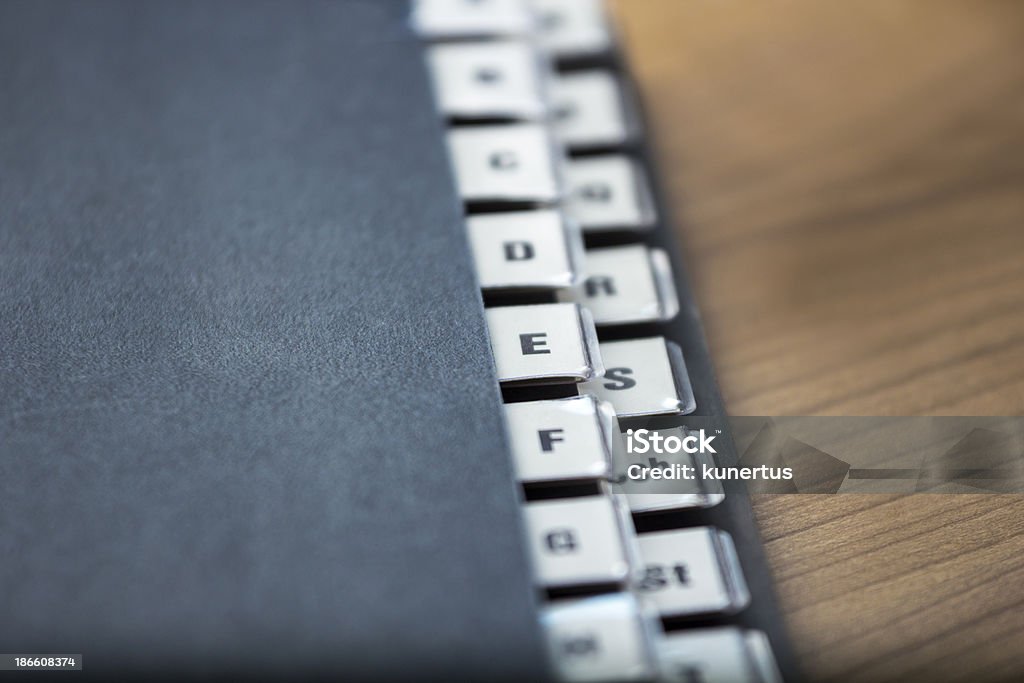 Alphabetical registry on a black folder alphabetical registry on a black folder on a wooden table, shallow depth of field Authority Stock Photo