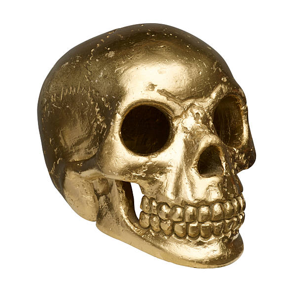 isolated golden skull on white background with clipping path stock photo
