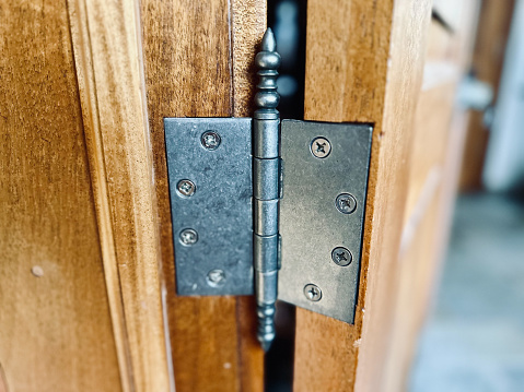 A close up image of the key hole on an old weather worn metal door knob.