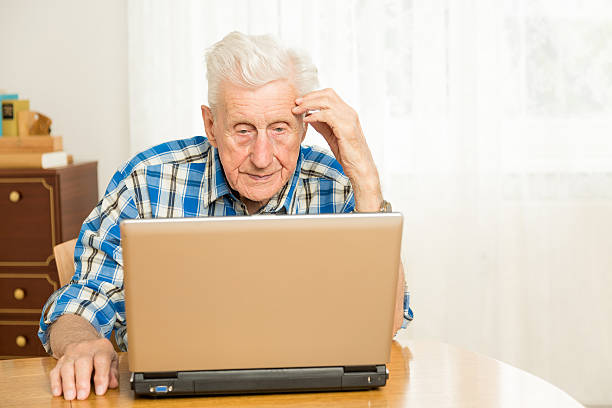 istock Senior man in front of a laptop computer 186610197