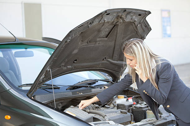 istock businesswoman having problem with her car 186610476