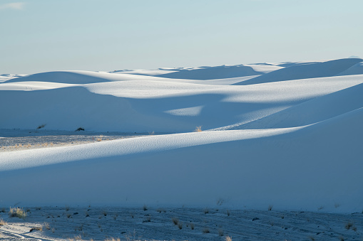 White Sands National Monument, NM, USA--December 30, 2014: two girls were turning a somersault on the white sand.