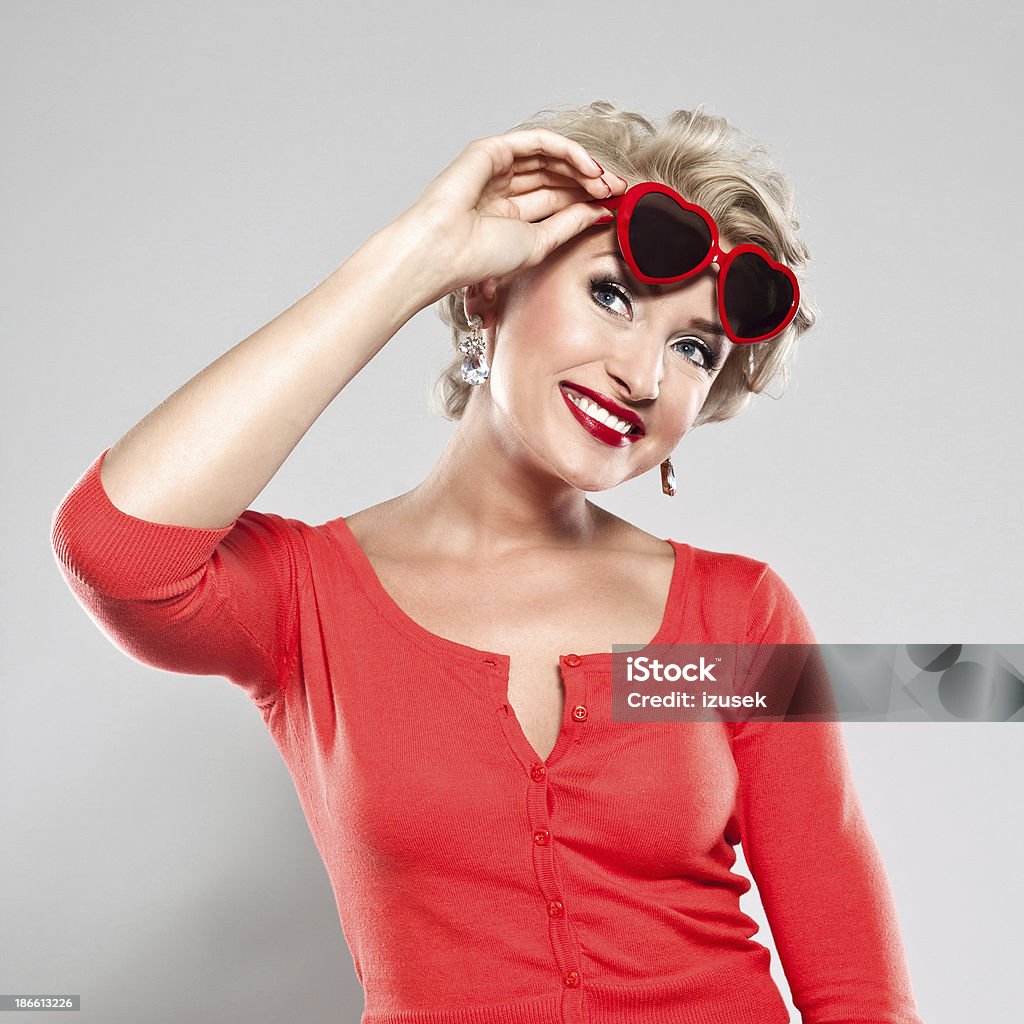 Elegant woman with heart shape glasses Portrait of happy woman wearing heart shape glasses. Females Stock Photo