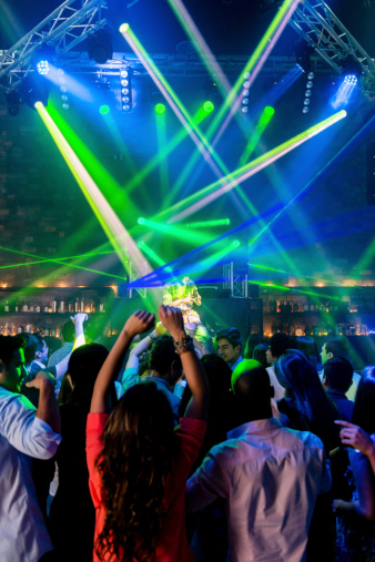 Group of people partying at a nightclub with live music