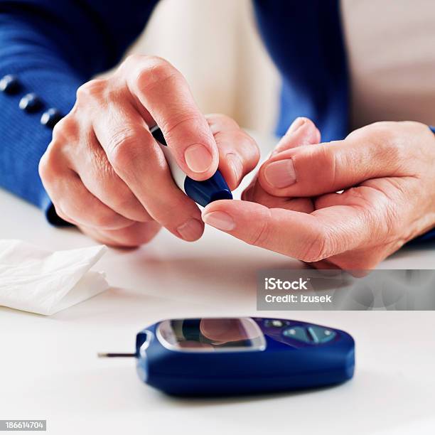 Woman Checking Glucose Level Stock Photo - Download Image Now - 60-64 Years, Active Seniors, Adult