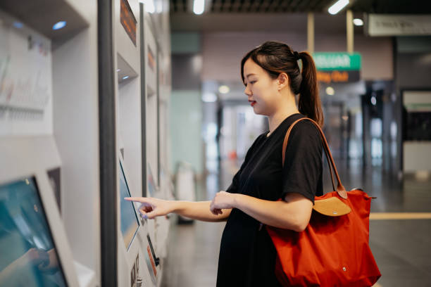 istock Pregnant woman buying train ticket 1866148091
